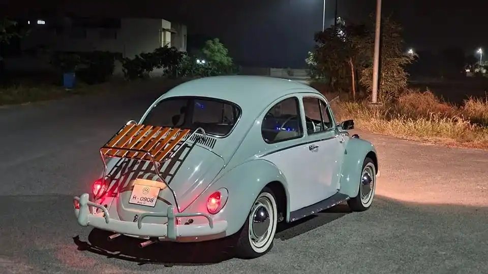 White VW Beetle with deck-lid rack fitted at night
