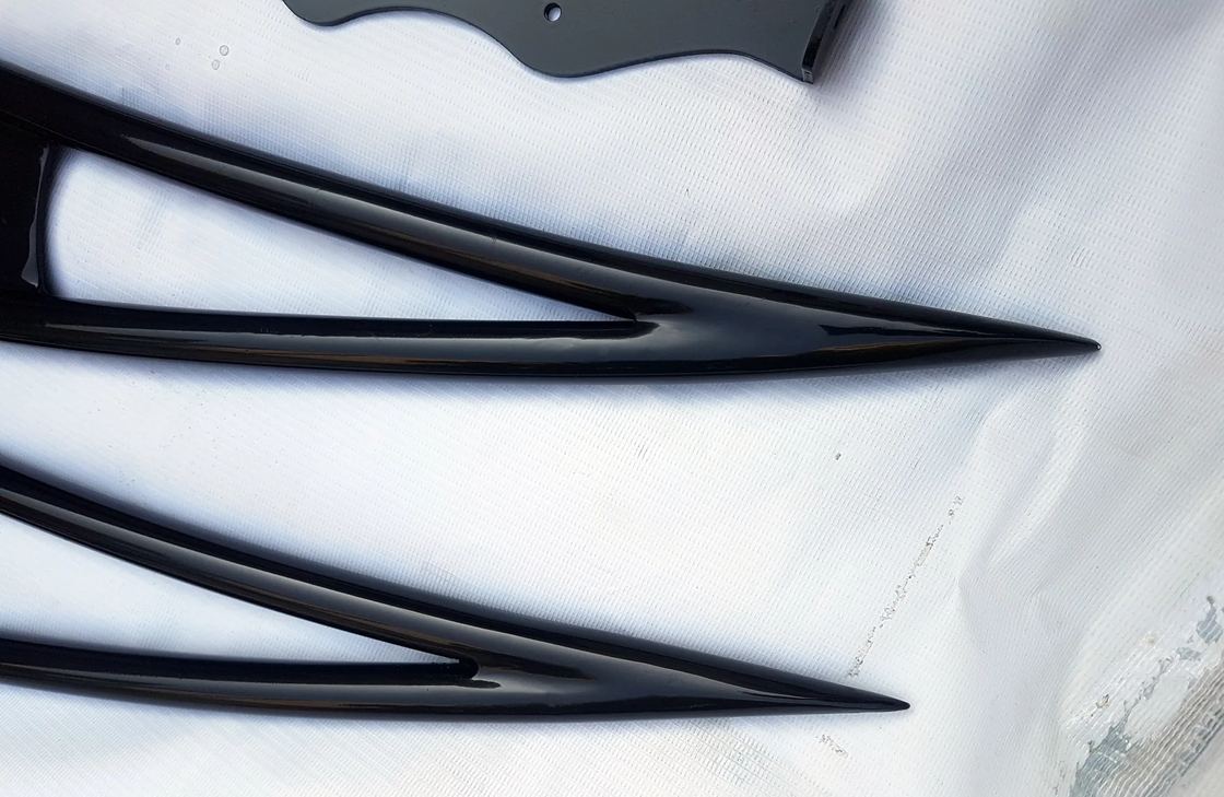 Black speed roof rack hardware and slat detail on white cloth
